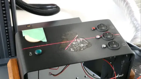 Fiber laser engraving machine etching a detailed gorilla logo and Avanti text onto black powder-coated metal housing.