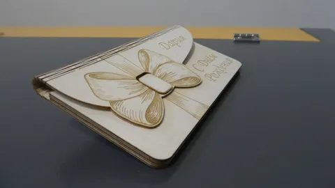 Side view of a wooden birthday envelope highlighting the multi-line laser cut living hinge curvature.