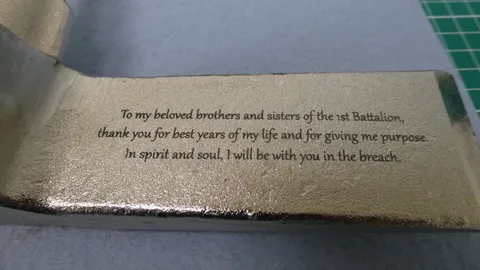 Close-up of crisp text laser engraved into textured steel for a military retirement gift presentation.