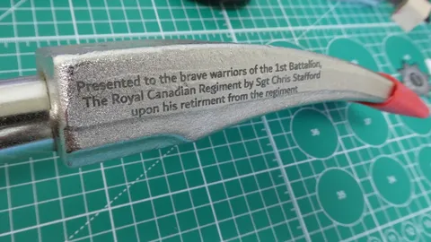 Laser engraved military retirement dedication message on the curved steel fork of a Halligan bar.