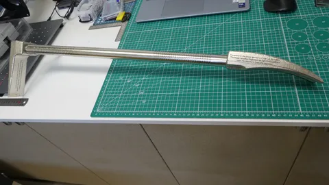 Finished custom laser engraved steel Halligan bar presentation piece showing deep text markings on both ends.