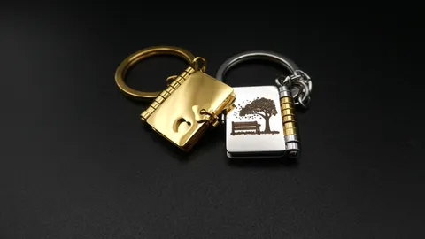 A custom metal miniature book keychain with micro-engraved personal messages. A sentimental gift from a mother to her children, featuring precision fiber laser detailing by TechArt Concept.