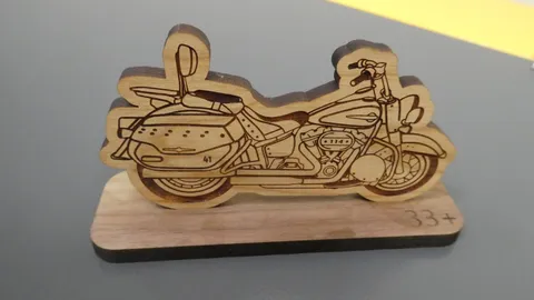 Custom laser engraved wooden motorcycle desktop display stand featuring precise technical line work.