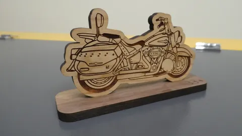 Angled view of a custom laser-cut wooden motorcycle trophy mounted on a solid wood base.